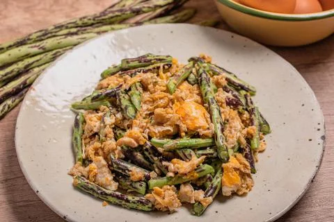 Stir fried Yardlong bean with eggs on wooden background Stock Photos