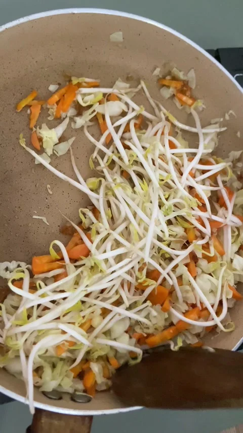 Stir Frying Bean Sprouts Cabbage and Carrots Asian Vegetable Dish Cooking Footag Stock Footage 310349971