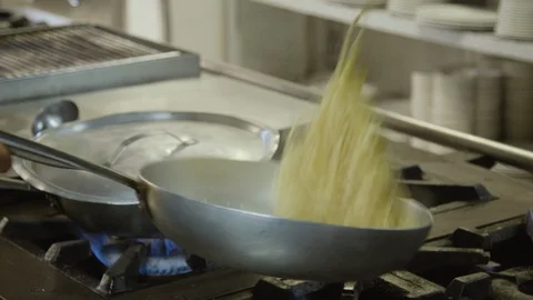 Stir-frying spaghetti in a pan Stock Footage 86203427
