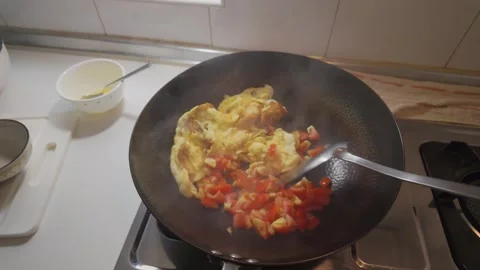 Stir Frying Tomatoes with Scrambled Eggs in an Iron Wok Stock Footage 346305670