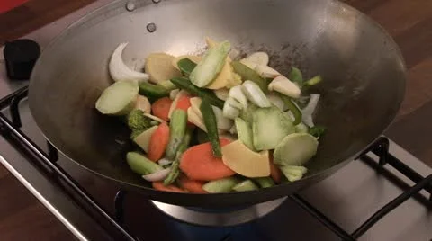 Stir-frying vegetables in a wok Stock Footage 24634425