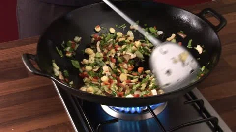 Stir-frying vegetables in a wok Stock Footage 24634479