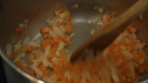 Stir the sizzling fried vegetables with a spoon. Close-up Stock Footage 314978910