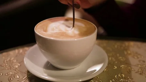 Stir with a spoon in a cup of coffee Stock Footage 82054482
