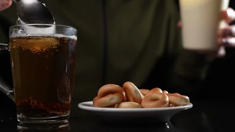 Stir sugar in a cup of tea. Slow motion Video stock 249229975