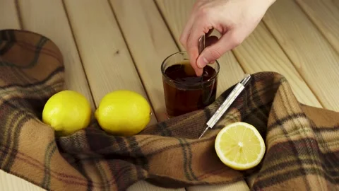 Stir the tea in a glass with a spoon Stock Footage 219314611