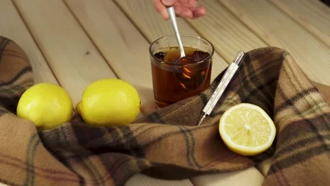 Stir the tea in a glass with a spoon Stock Footage 219314656