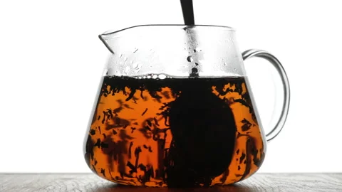 Stir the tea in the teapot with a spoon. Process brewing tea, tea ceremony Stock Footage 154626444
