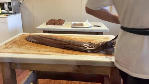 Stir Tempered Chocolate On Granite Table Stock Footage 295570679