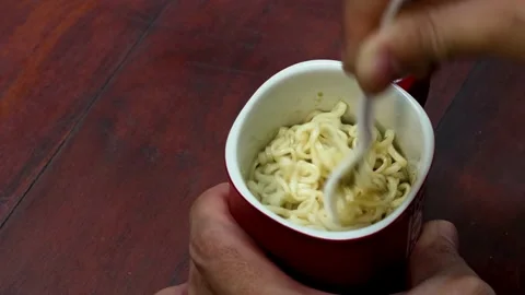 Stiring noodle in the mug Stock Footage 204562516