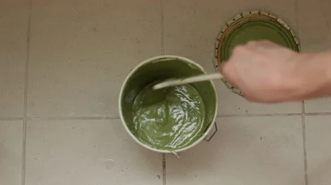 Stiring paint in a bucket Stock Footage 68790103