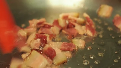 Stirring bacon while it fries Stock-Footage 128001663