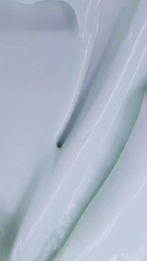 Stirring beauty cream evenly using a metal tool. Vertical close up top view.. Stock Footage 339305198