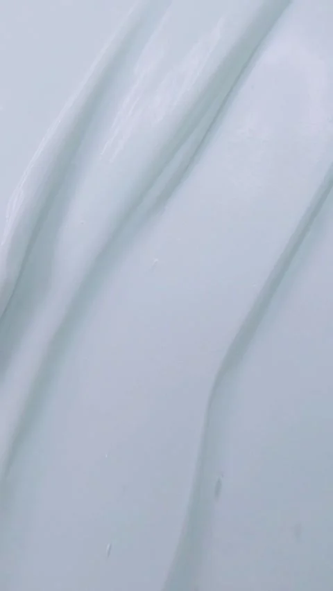 Stirring beauty cream slowly using a metal spoon. Vertical close up view fo.. Stock Footage 339566790