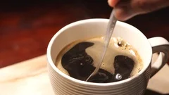 Stir the hot coffee in a cup with a spoo, Stock Video