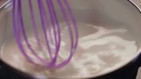 Stirring A Boiling Pot Of Milk or White Sauce. Stock Footage 146127304