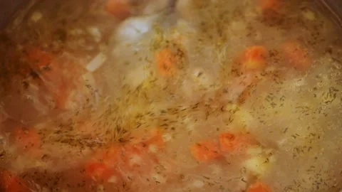 Stirring boiling soup with a spoon Stock Footage 133352683