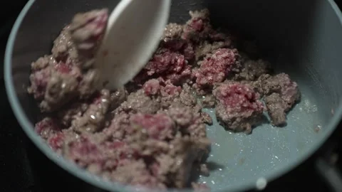 Stirring browning meat Stock Footage 243399173