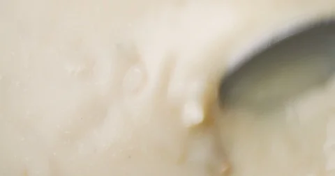 Stirring canned clam chowder with a spoon Stock Footage 102001570