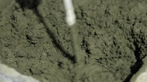 Stirring cement mortar with a hammer drill Stock Footage 270218563