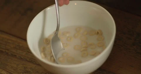 Stirring Cereal in Milk with Spoon Stock Footage 169724296