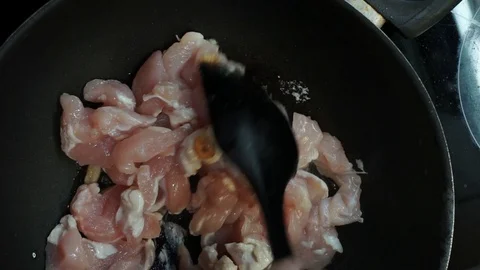 Stirring chicken overhead Stock Footage 98360863