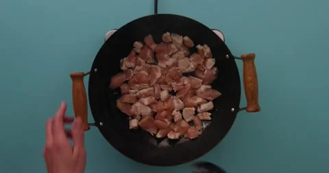 Stirring chicken while it cooks in a skillet 3 Video stock 132199369