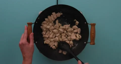 Stirring chicken while it cooks in a skillet 4 Video stock 132199430