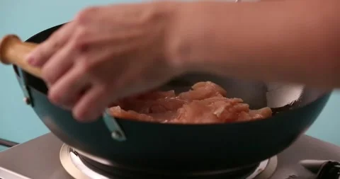 Stirring chicken while it cooks in a skillet 5 Stock Footage 132199546