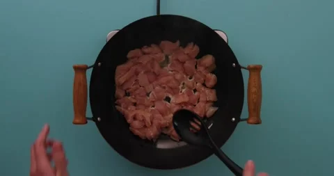 Stirring chicken while it cooks in a skillet 2 Stock-Footage 132199590