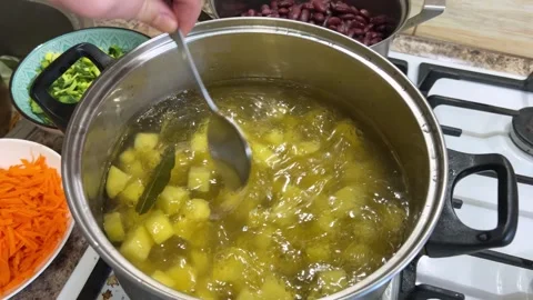 Stirring chopped potatoes in a boiling pan. Process of cooking Ukrainian borscht Video stock 302278426