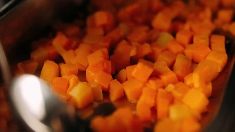 Stirring chopped pumpkin on the pan Stock Footage 125458465