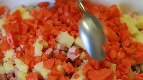 Stirring chopped vegetables in a salad Stock Footage 129888491