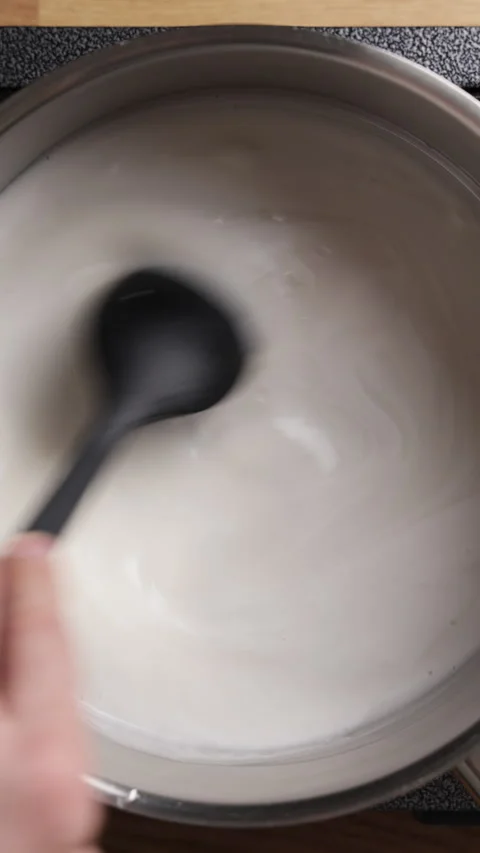 Stirring Coconut Milk With Sugar Using Silicone Spatula Vertical Top View Видео 335039066