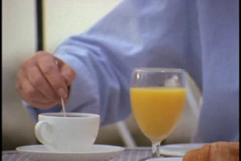 Stirring coffee at breakfast Stock Footage 10579534
