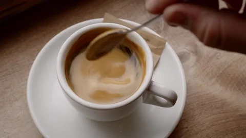 Stirring coffee at a Cafe Video stock 254728399
