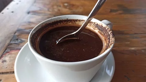 Stirring the coffee in the cup Stock Footage 153988659