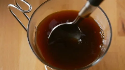 Stirring coffee in mug, overhead CU slow motion Video stock 48820520