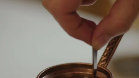 Stirring coffee in a pot, 4k slow motion  Stock Footage 98881805