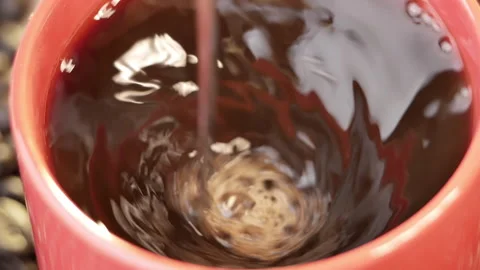 Stirring coffee with spoon on roasted coffee beans background. Fresh morning. Stock Footage 153250391