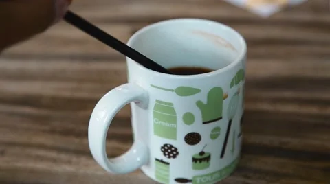 Stirring coffee on table Stock Footage 65829208