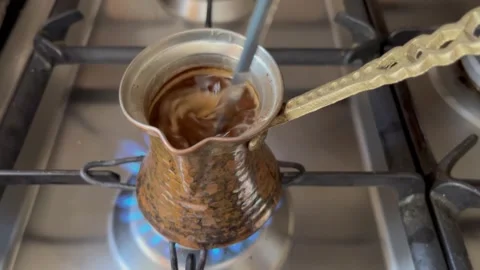 Stirring Coffee in a Traditional Copper Cezve on the Stove Stock Footage 345304589
