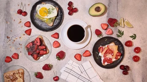 Stirring coffee.Breakfast different toasts with berries, cheese, egg and fruit Stock Footage 132736201