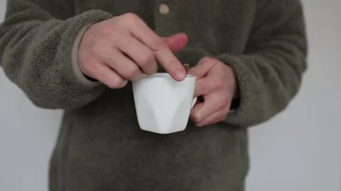 Stirring a cold drink with a spoon in a cup Video stock 345725823