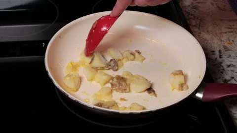 Stirring Cooking Pre-Boiled Brown Skins Potatoes in a Frying Pan Stock Footage 134066688