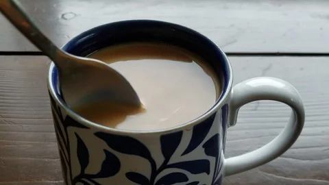 Stirring creamer into mug of coffee Stock Footage 111747277