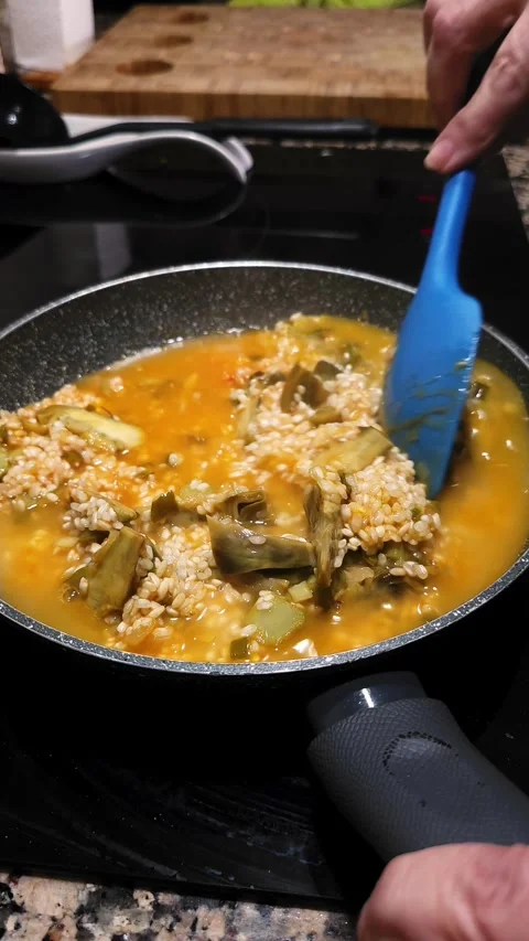 Stirring creamy risotto with artichokes. Stock Footage 345152204