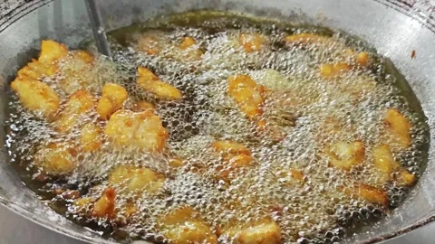 Stirring crispy fried fish in a large wok with a spatula. Stock Footage 342739792