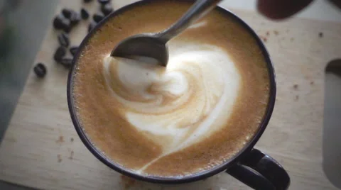 Stirring a cup of cappuccino, slow motion Stock Footage 60958846