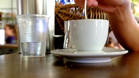 Stirring a cup of coffee in a Bar Stock Footage 79810265